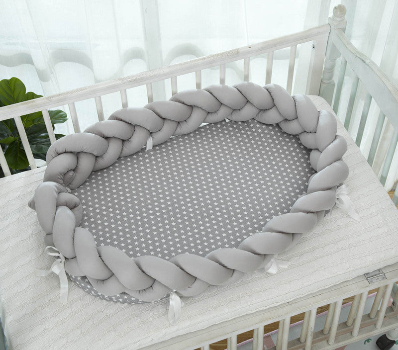 Réducteur de lit bébé tressé gris STARRYBABYNEST™ dans un berceau