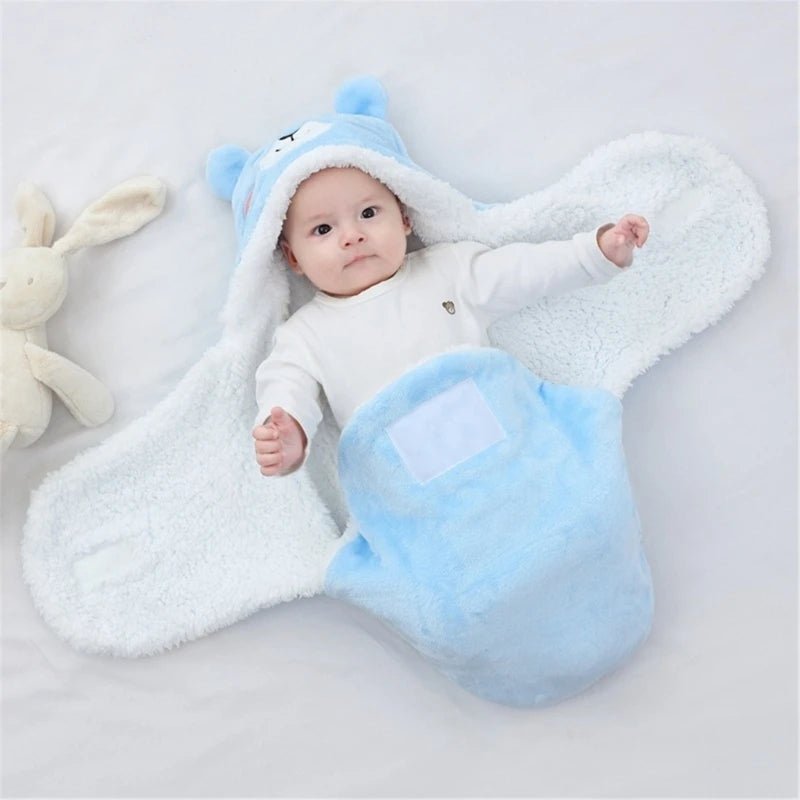BEBE ALLONGE DANS NOTRE COUVERTURE D EMMAILLOTAGE ANIMALSNUGGLE™ OURS BLEUE