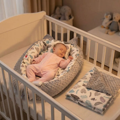 BEBE DORMANT SUR NOTRE REDUCTEUR DE LIT POUR BEBE SOOTHINGFOLIAGE™ DANS SON BERCEAU
